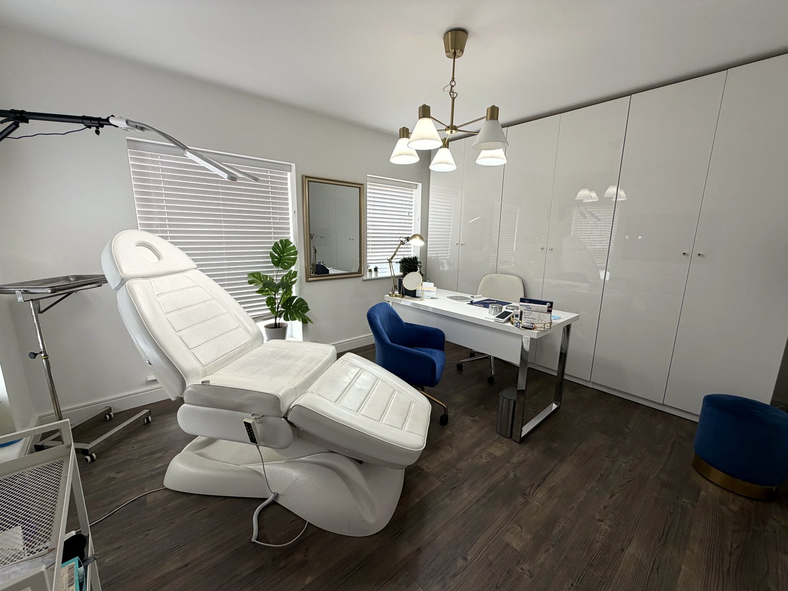 The treatment room at PortoClinic Aesthetics in Kings Hill, West Malling — treatment chair, consultation desk and daylight from the window